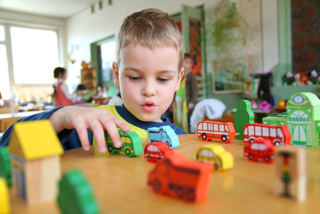 Boy playing with transport toys