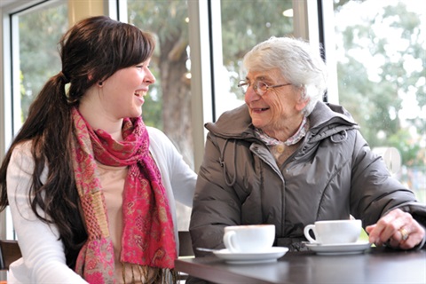 Elderly lady in cafe with support worker